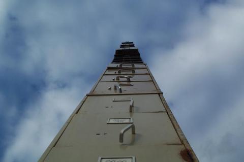 Worm-eye view of a giant stack of busted filing cabinets.