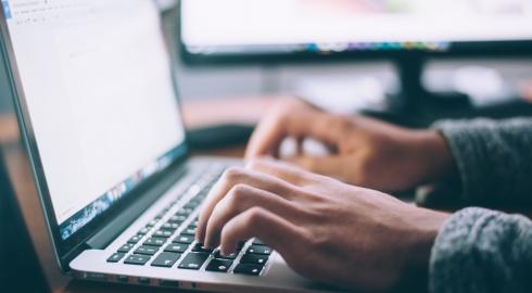 Closeup of a developer working on a laptop