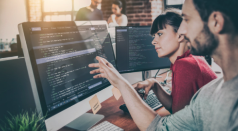 Two people building a website in an office